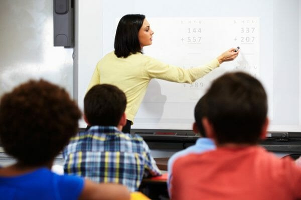 Teacher teaching math at a whiteboard