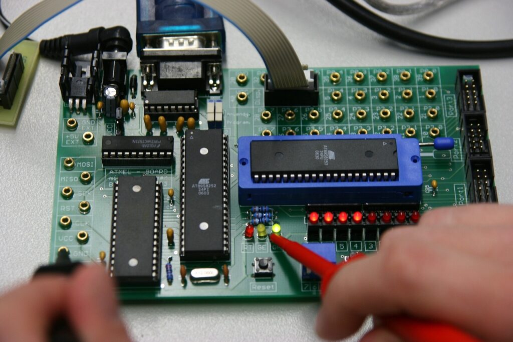 Picture of a circuit board with someone testing power flow