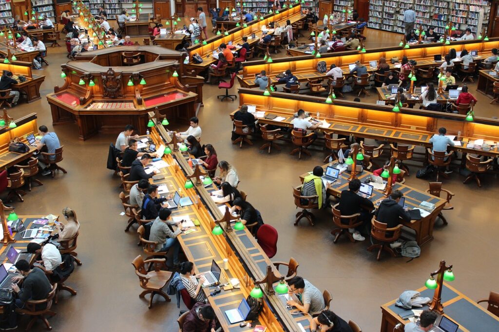 Large group of students learning in a library